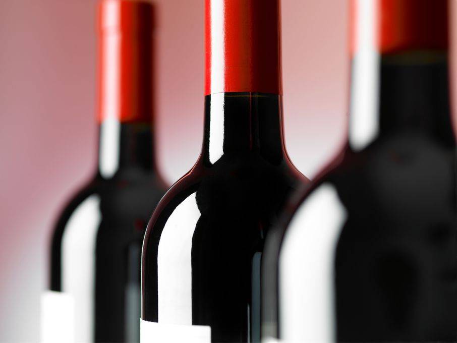 three red wine bottles closeup