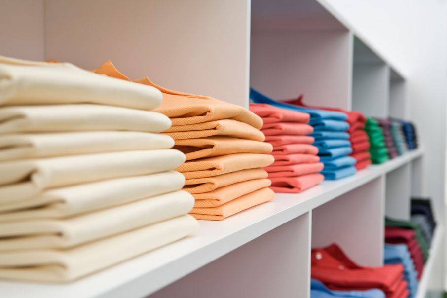 colorful shirts on shelves at a store